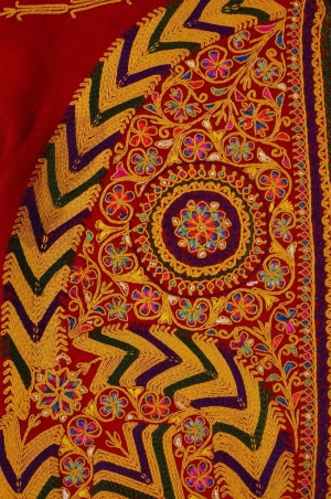 A detail from a woman&rsquo;s jacket from Bethlehem showing the use of cord couching with embroidery to create stylised floral motifs with floss silk details (early 20th century).