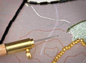 Photograph showing the use of a tambour hook.