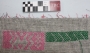A white piece of canvas used as a guide for cross stitch embroidery on a ground cloth underneath. Jordan, 1970's.