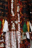 Detail of the embroidery on a black headdress and white wedding dress from the Siwa oasis, showing the traditional Siwa colours and the mother-of-pearl buttons, 1970's.