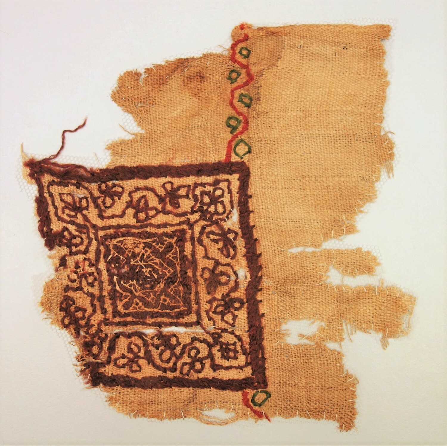 Fig.1. Fragment of linen with an embroidered design worked in wool, probably from a child's tunic Egypt, 5th-6th century AD  (TRC 2000.0014).