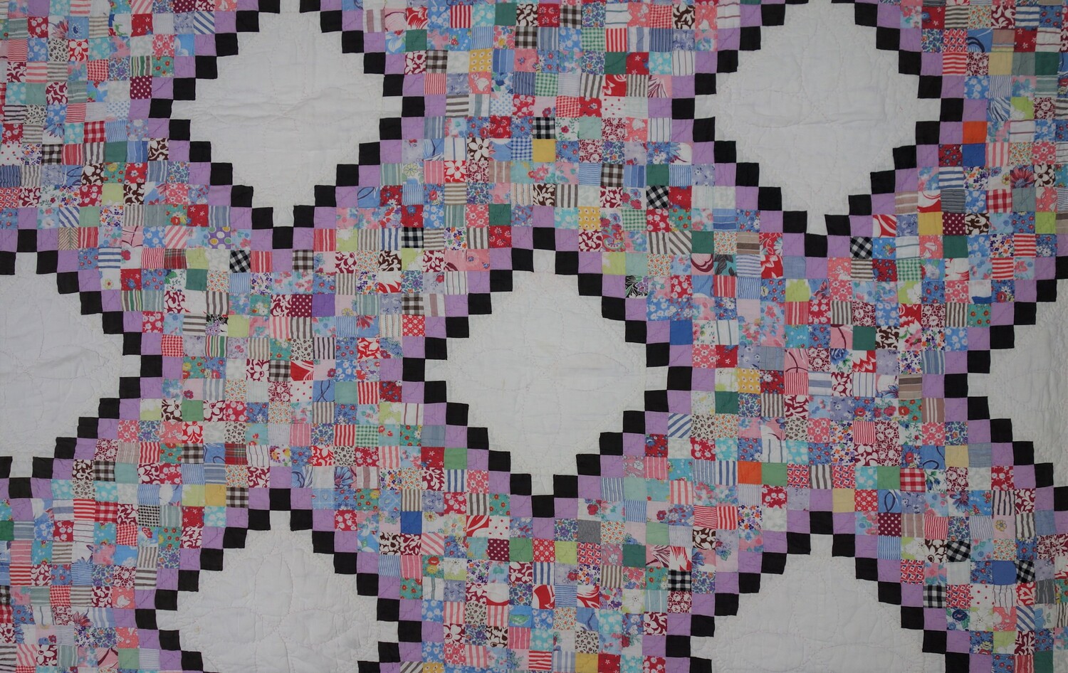 Detail of a mid-20th century postage stamp quilt from the USA (TRC 2017.4253).