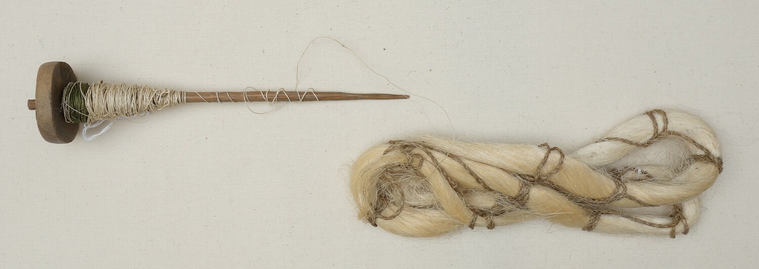 Fig. 4. TRC 2020.2796a Spindle with a stick shaft and a disc whorl. There is a spun, bast thread ('hanna') wrapped around the spindle shaft. Sri Lanka, 20th century (TRC 2020.2796a).
