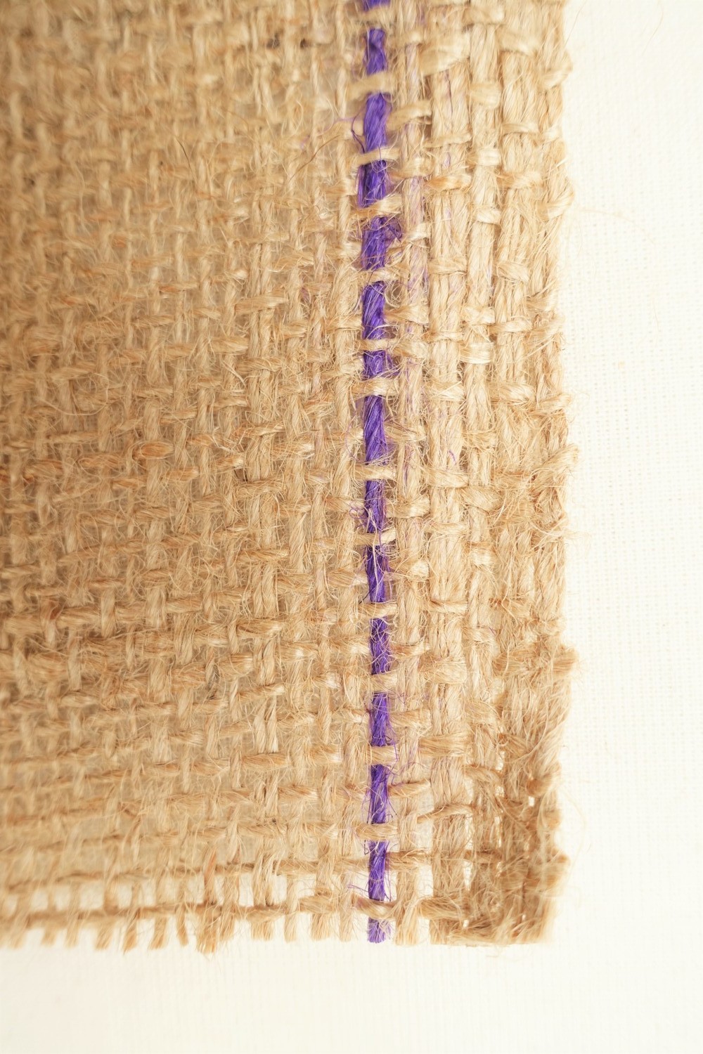 Fig. 2. Brown hessian cloth with selvedge to the right, with a narrow purple selvedge stripe and double warps (TRC 2023.0849b).