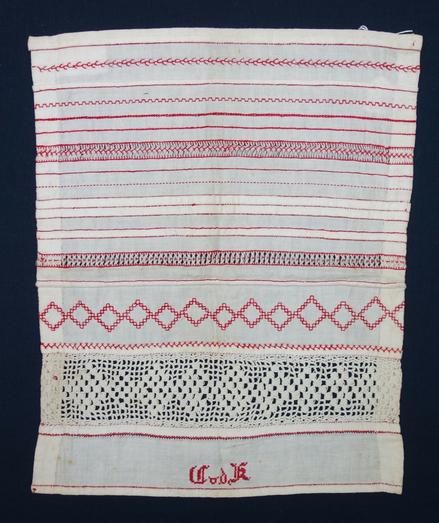 Fig. 6: Sample with a series of different sewing and embroidery stitches, hems, seams, as well as an embroidered band (double running stitch), and a crochet lace inset. Worked by Cato van der Kleij, Hoek van Holland, 1918, when she was about 8 years old (TRC 2024.1725.02).