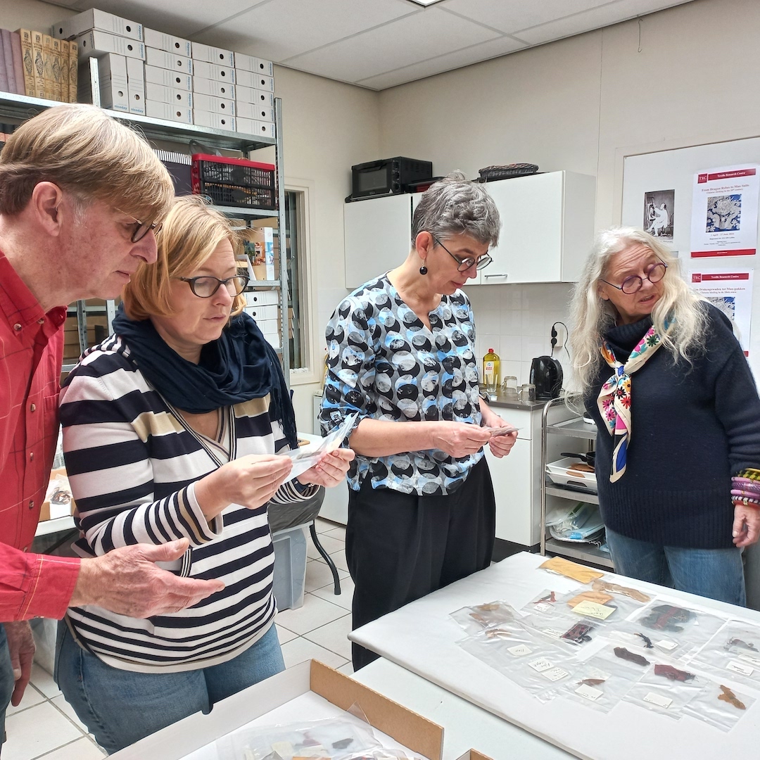 Karel Innemée (left) and Polish delegation comparing actual Jebel Adda textiles with replica dyes from Poland.