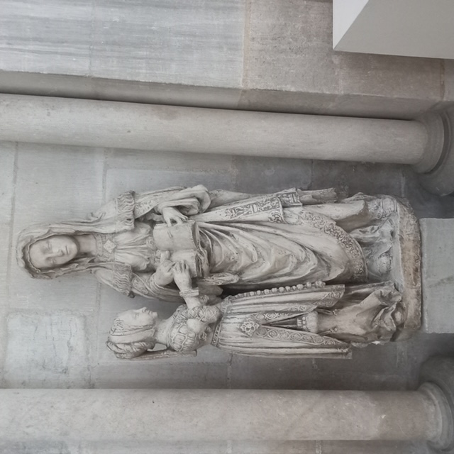 Medieval statue of the Virgin Mary being taught by St Elizabeth (?). Troyes Cathedral. The statue shows the rich garments of Mary and her teacher. Photograph by author.