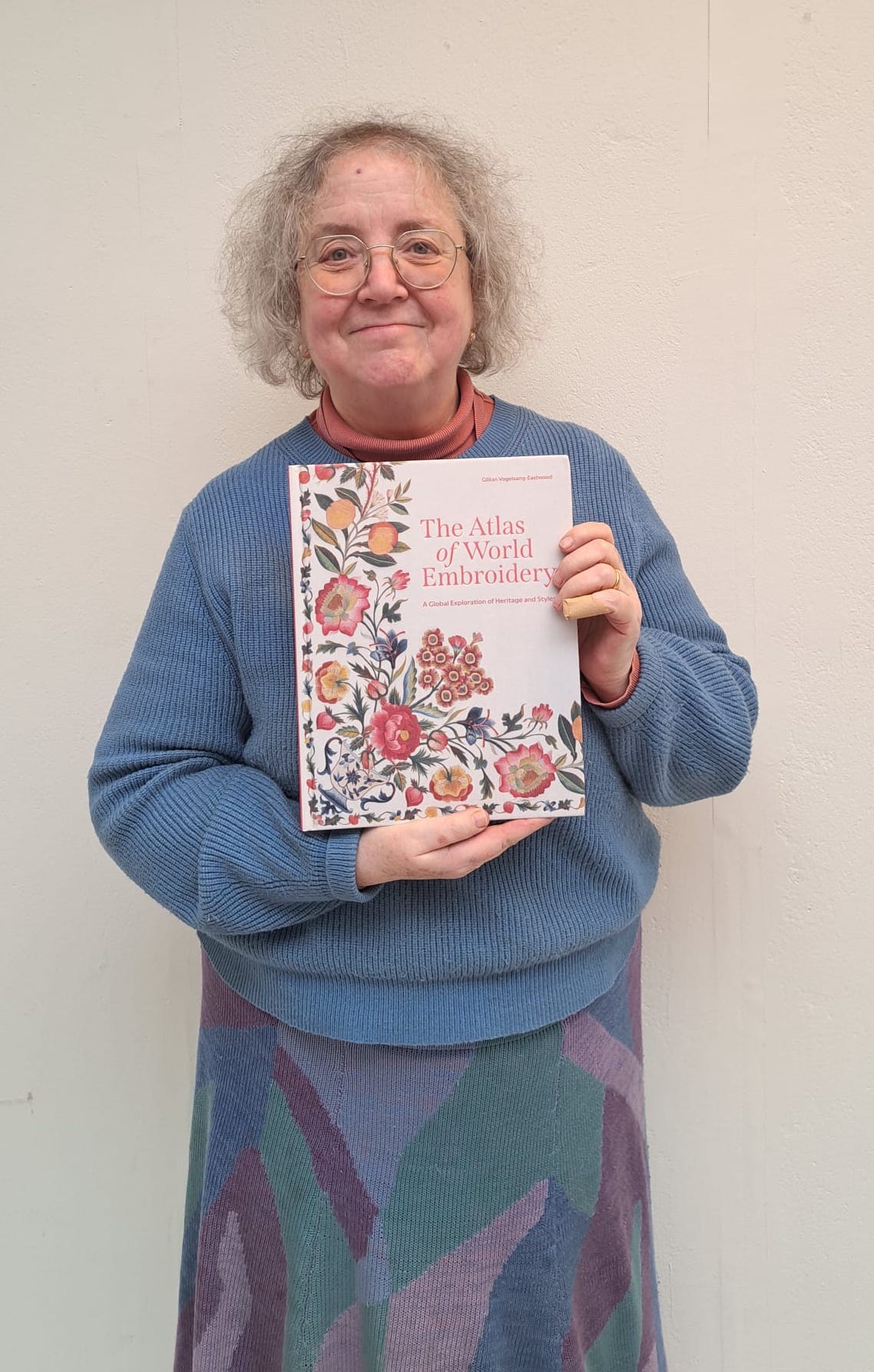 The proud author with her first copy of The Atlas of World Embroidery