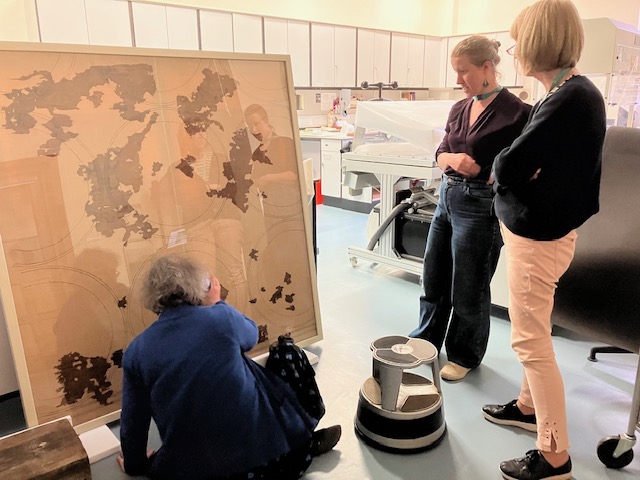 Studying fragments of one of the early medieval textiles found in St Cuthbert's tomb. 26 May 2023. Photograph: Willem Vogelsang