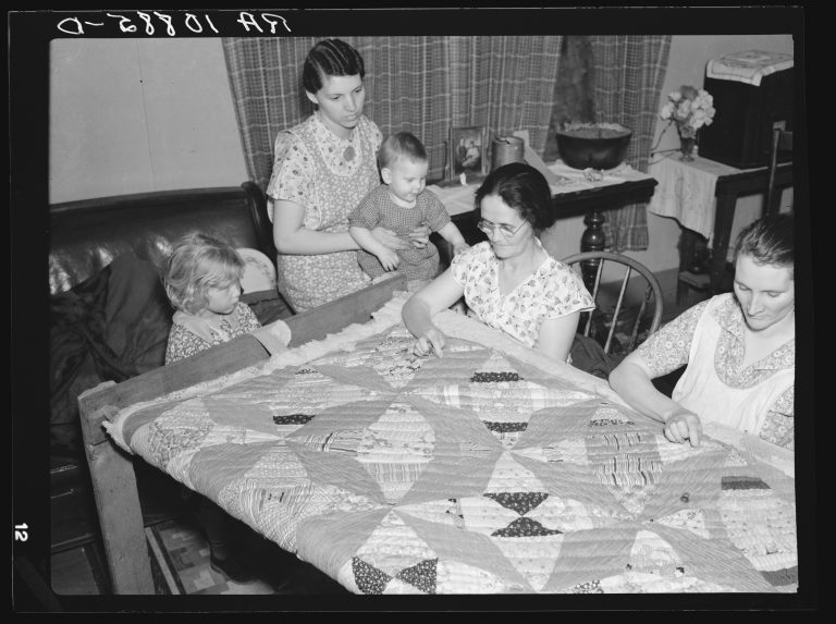 Women working a quilt under the 1930s WPA Sewing Room Project (Lee LC USF34 010885 D 768x573).