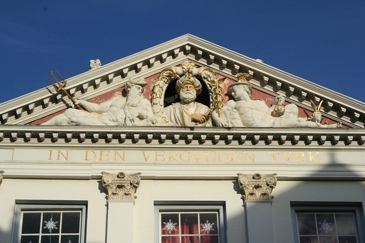Leiden: City of Textiles. The frieze on top of the Vergulde Turk, Breestraat Leiden, showing Neptune (overseas trade), the Ottoman admiral Barbarossa, Mercury (trade), and peeping over Neptune's leg there is an angora (compare Ankara) goat (mohair!) to the right, all of it representing Leiden and its textile trade, especially in mohair, with Turkey, mid-17th century.