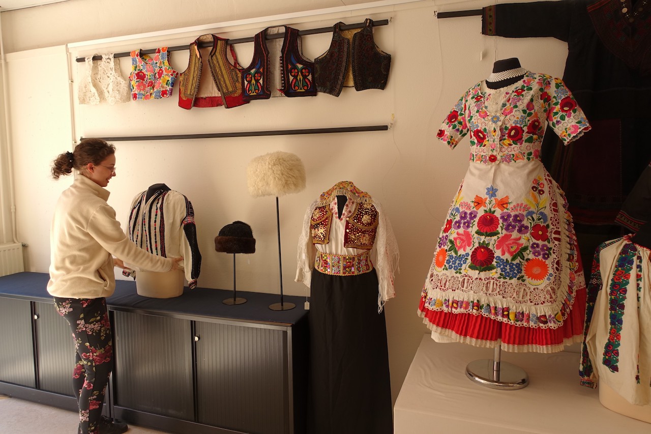 TRC volunteer preparing the pop-up exhibition of East European traditional clothing, for Sunday afternoon 24 April.