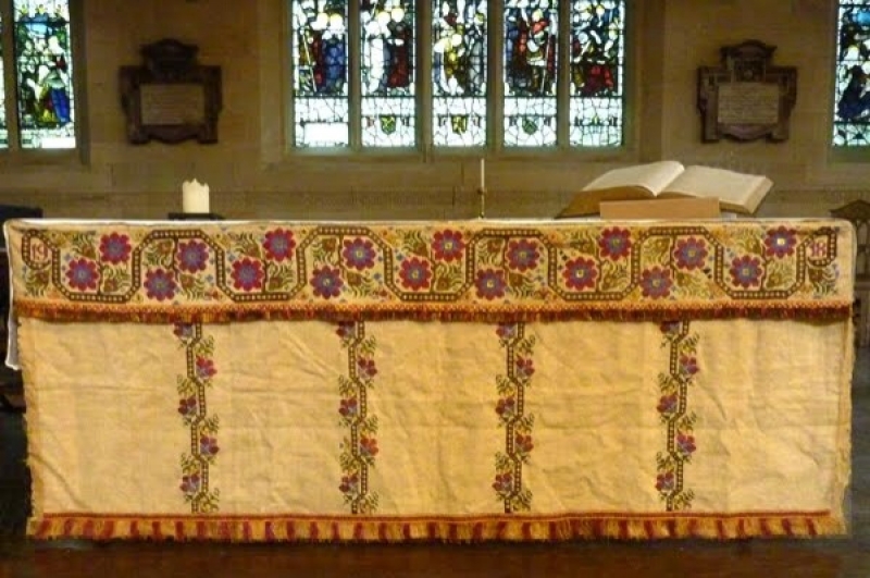 The Khaki altar cloth: An altar superfrontal worked in cross stitch on linen, made by the Khaki Club in the Abram Peel Hospital by wounded soldiers in 1917/1918, now in Bradford Cathedral.
