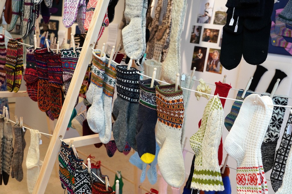 Rack of hand knitted socks from around the world. Socks&Stockings exhibition, TRC, 2019. Photograph by Joost Kolkman.
